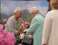 Presenting HM The Queen with a bouquet of rhododendrons